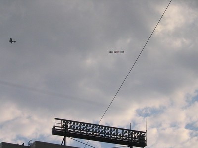 plane and banner over a stadium