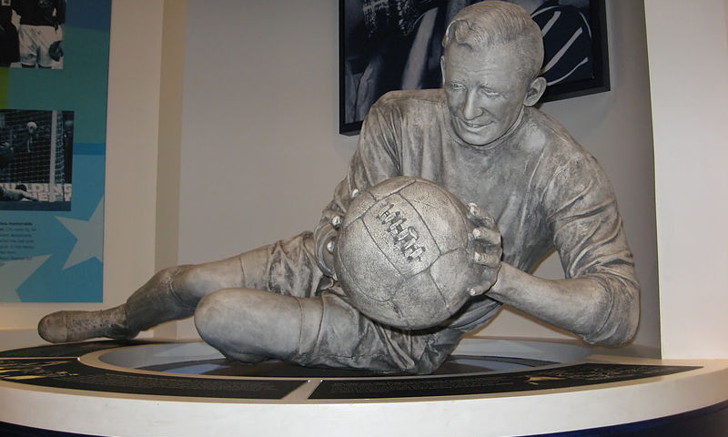 Statue Holding Old Football